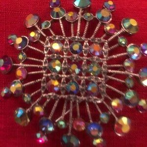 Fashion jewelry iridescent stone spiral brooch.